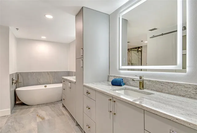 a bathroom with a bathtub and shower