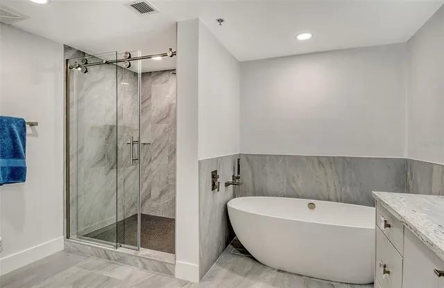a bathroom with a glass shower door