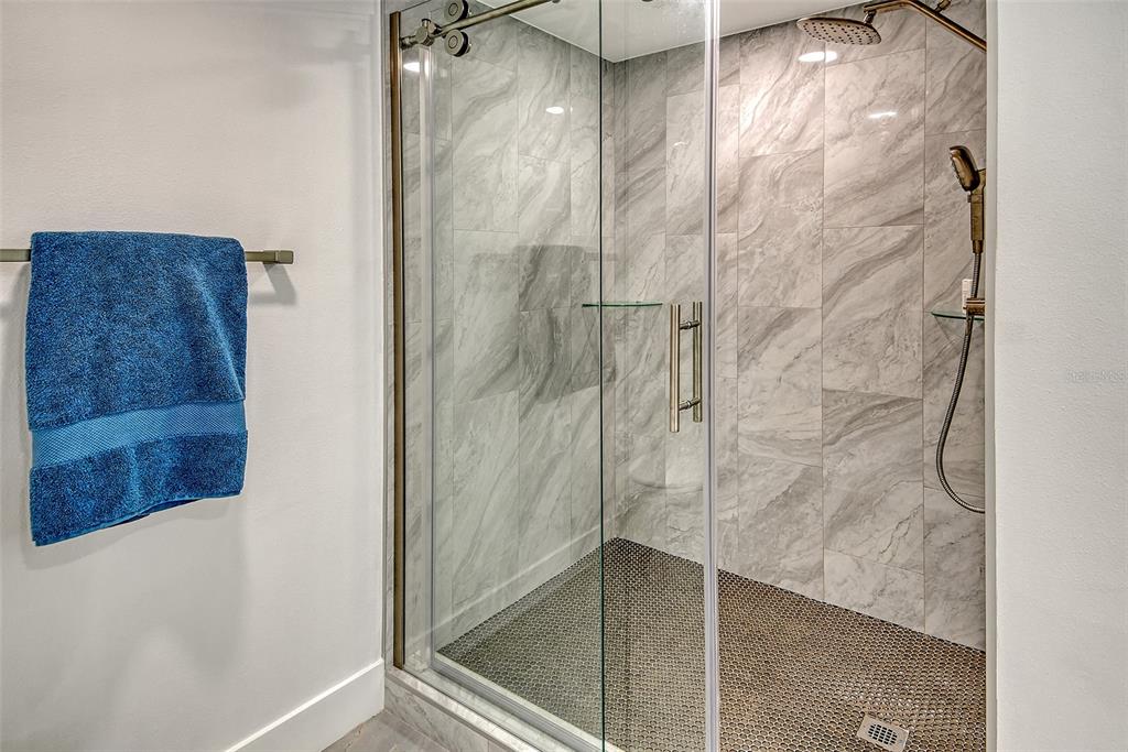 1255 North Gulfstream Avenue, Unit 702 Sarasota, FL 34236 - Photo 26 of 53 a bathroom with a glass shower door
