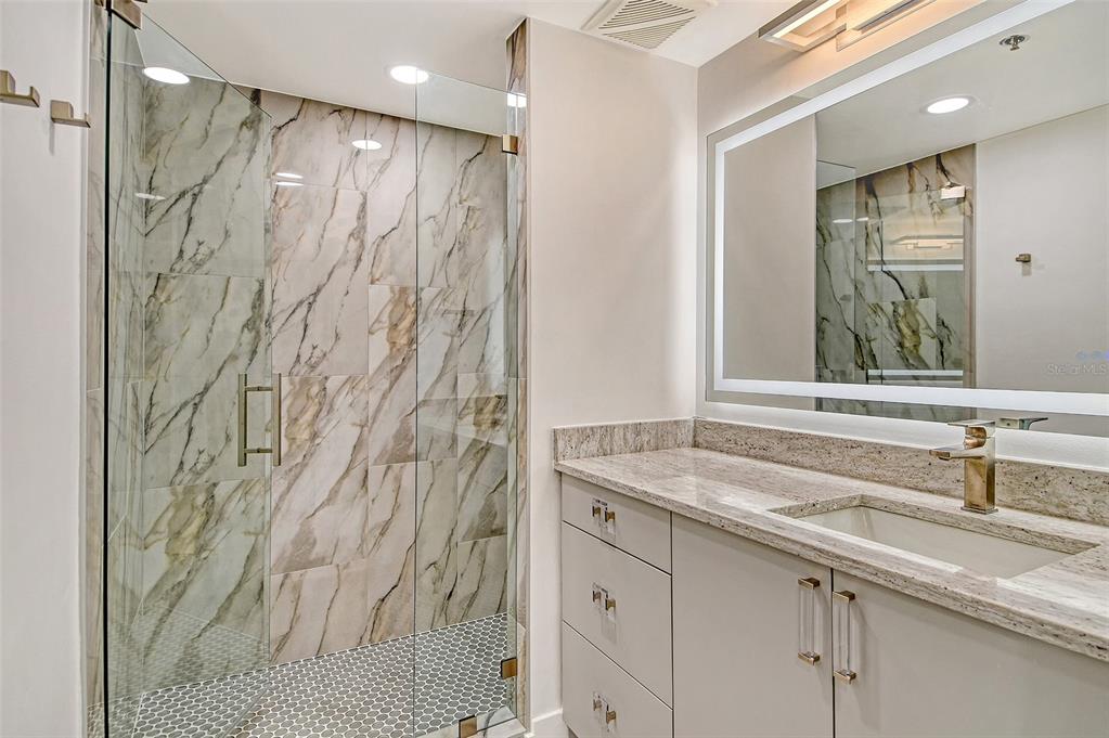 1255 North Gulfstream Avenue, Unit 702 Sarasota, FL 34236 - Photo 37 of 53 a bathroom with a sink and a mirror