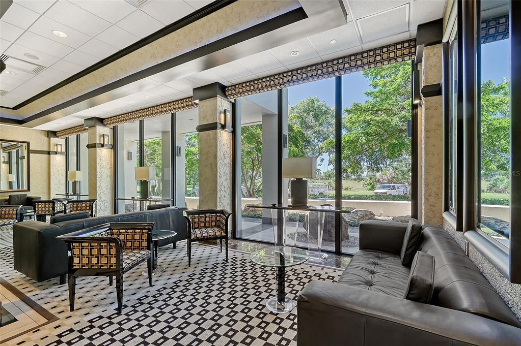 1255 North Gulfstream Avenue, Unit 702 Sarasota, FL 34236 - Photo 39 of 53 a living room with furniture tv and large windows