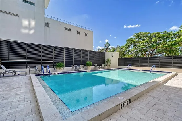 a view of a backyard with plants and a patio