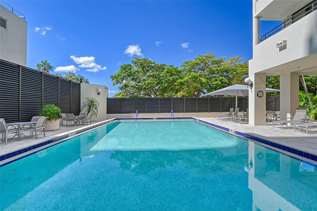 1255 North Gulfstream Avenue, Unit 702 Sarasota, FL 34236 - Photo 48 of 53 a view of a backyard with plants and a patio