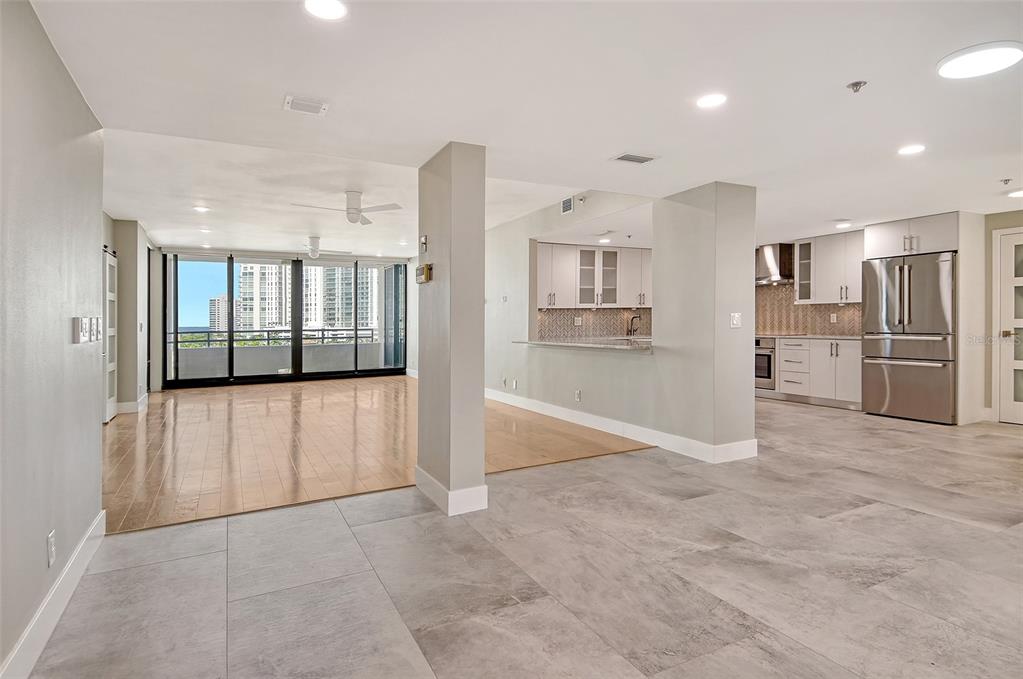 1255 North Gulfstream Avenue, Unit 702 Sarasota, FL 34236 - Photo 6 of 53 a view of a kitchen with refrigerator and wooden floor