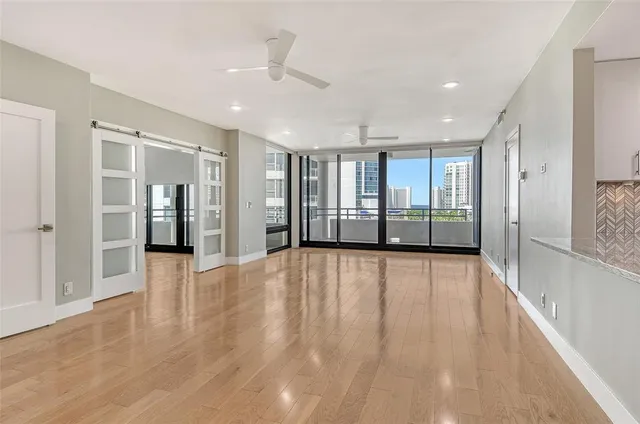 a view of an empty room with wooden floor