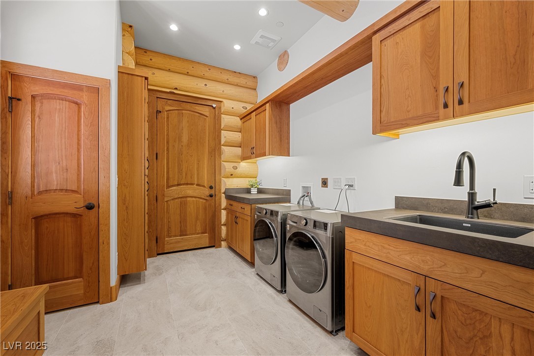 4927 Snow White Road Mount Charleston, NV 89124 - Photo 12 of 65 Laundry room area with ski storage closet, American Cherrywood cabinetry, washer, dryer and a sink, recessed lighting, garage entrance