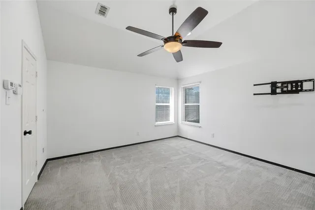 a view of a livingroom with a ceiling fan and window