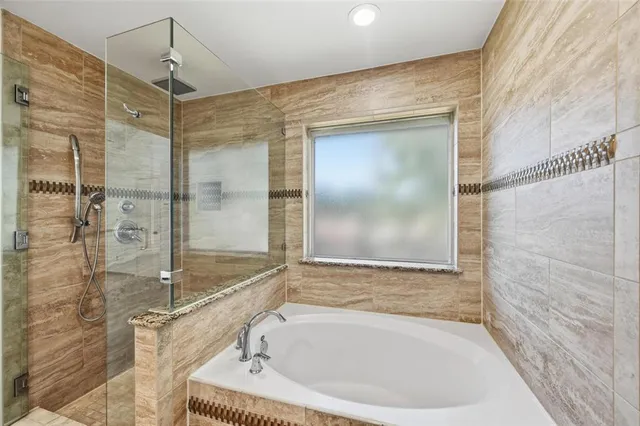 a bathroom with a tub and shower