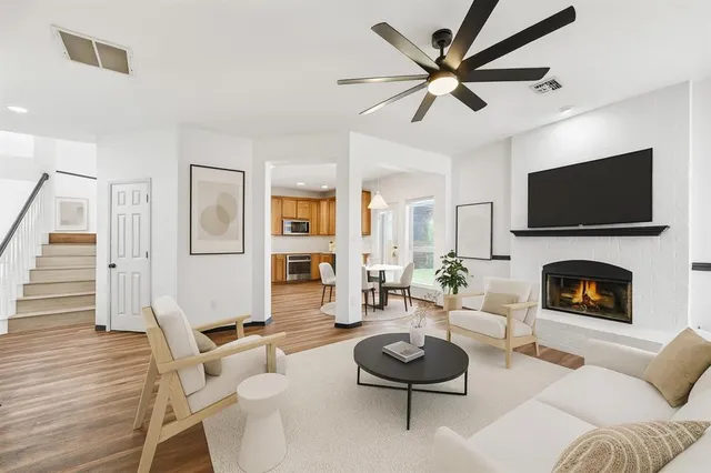 a living room with furniture a fireplace and a flat screen tv