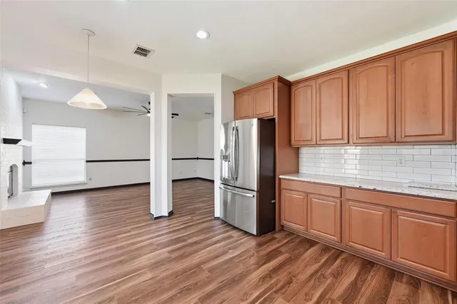 a kitchen with stainless steel appliances a refrigerator and a sink