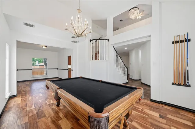 a kitchen with granite countertop a stove a sink and a wooden floor