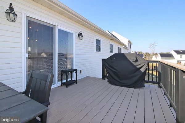 a balcony with wooden floor and furniture