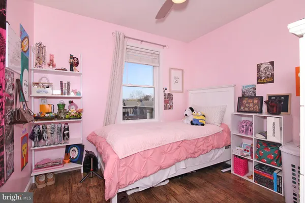 a bedroom with a bed and a book shelf