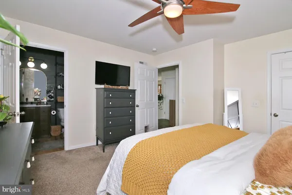 a bedroom with a bed and a television
