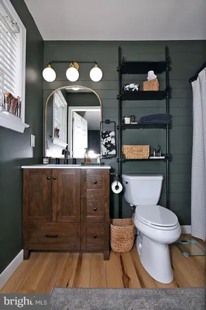 a bathroom with a toilet a sink and a mirror
