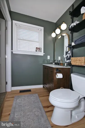 a bathroom with a toilet a sink and mirror