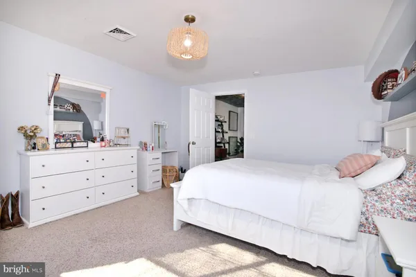 a bedroom with a bed and a dresser