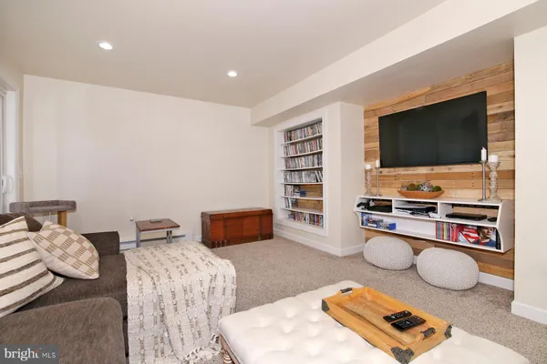 a hall with furniture and a flat screen tv