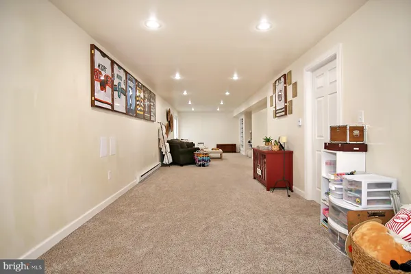 a living room with furniture and paintings on the wall
