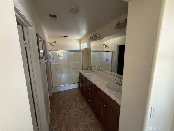 a view of a kitchen with a refrigerator and wooden floor