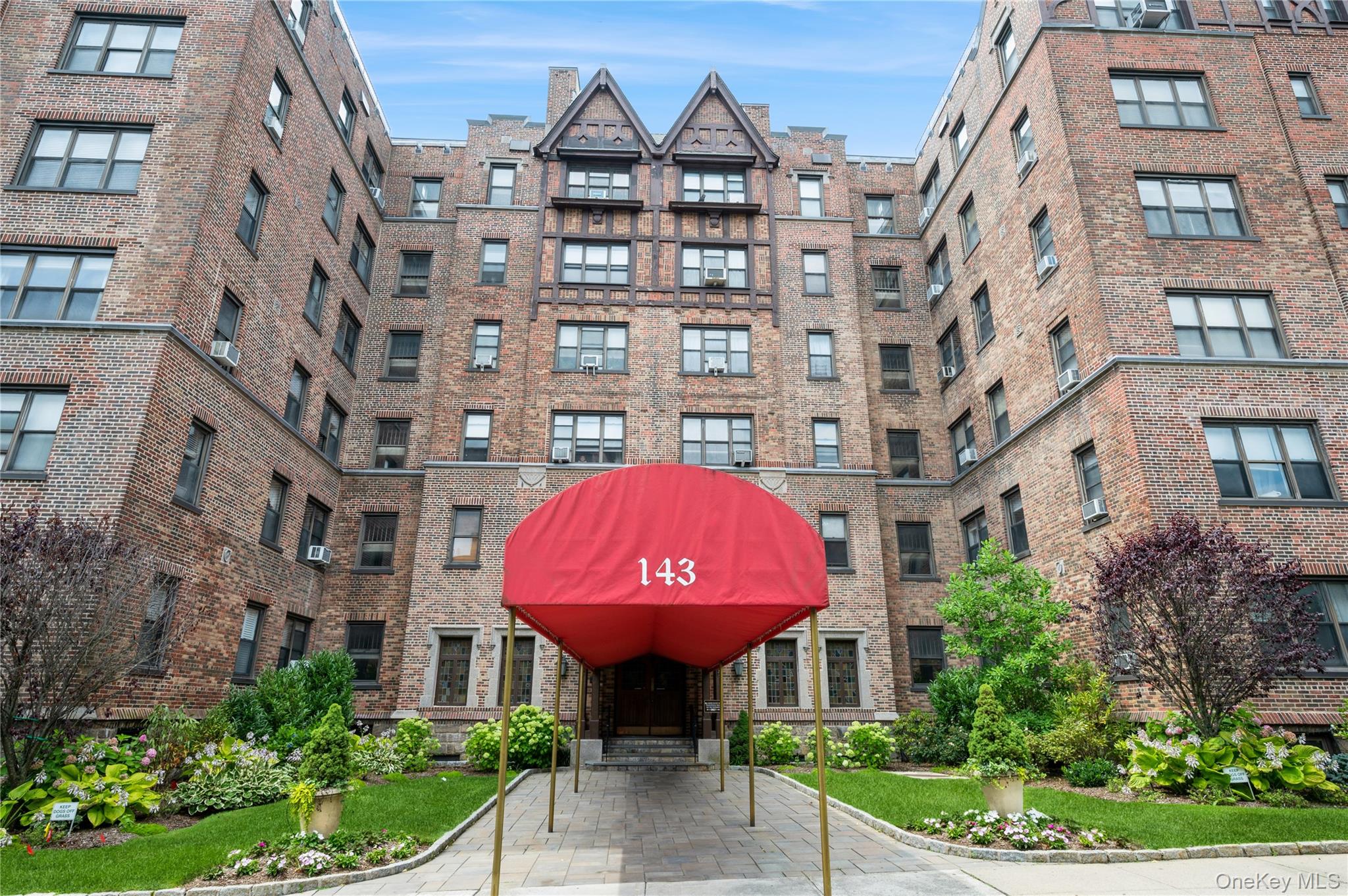a front view of a multi story residential apartment building with a yard
