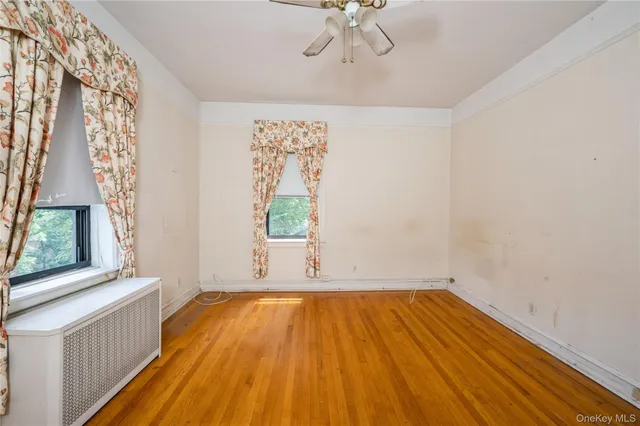 a view of a room with wooden floor and windows