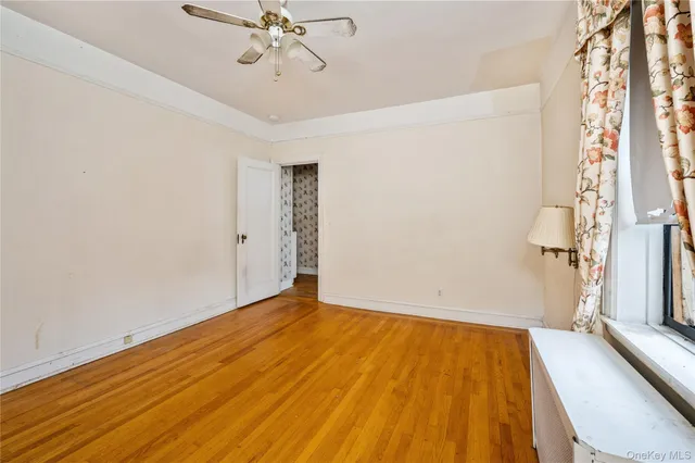 a view of room with hardwood floor and ceiling fan
