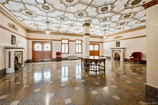 a living room with fireplace furniture and a chandelier