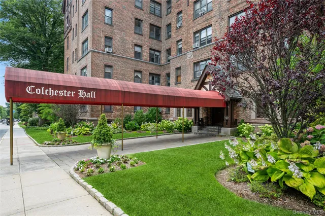 a front view of building with yard