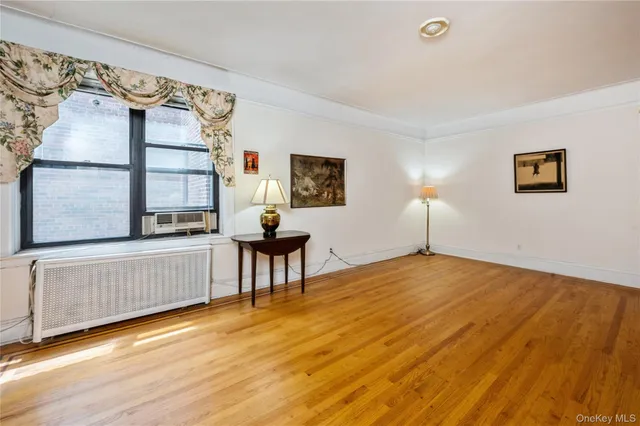 a view of a bedroom with furniture and wooden floor