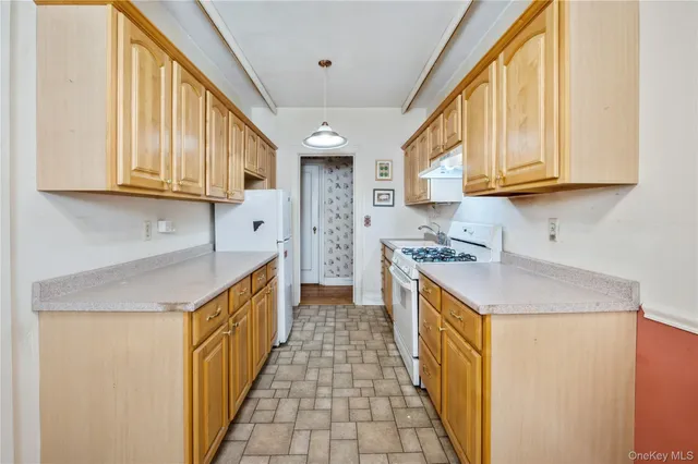 a kitchen with stainless steel appliances granite countertop a sink and dishwasher a stove with wooden cabinets