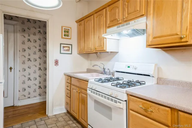 a kitchen with stainless steel appliances granite countertop a stove and a refrigerator