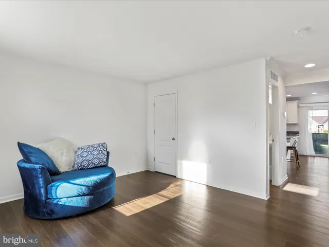 a living room with furniture and a hard wood floor