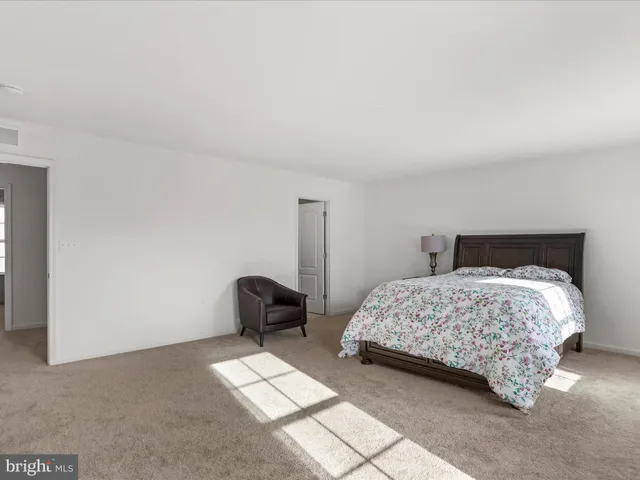 a bedroom with a bed and chair