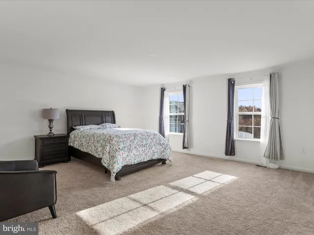 a bedroom with a large bed and dresser