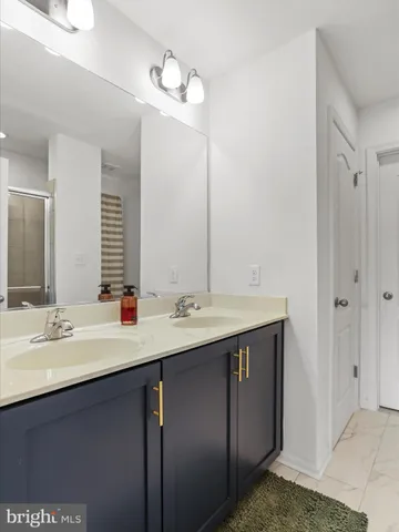 a bathroom with a double vanity sink and a mirror
