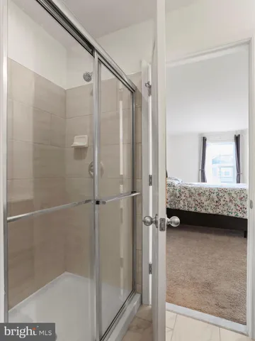 a bathroom with a glass shower door