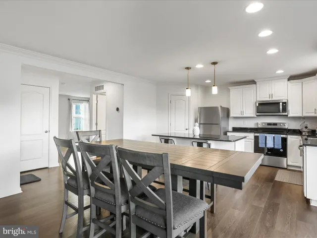 a kitchen with a table and chairs in it