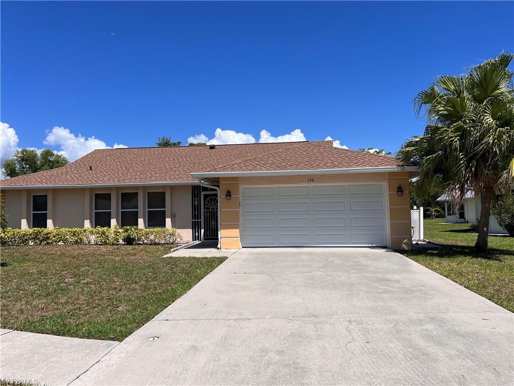 140 Bordeaux Circle Naples, FL 34112 - Photo 1 of 22 a front view of a house with a yard and potted plants