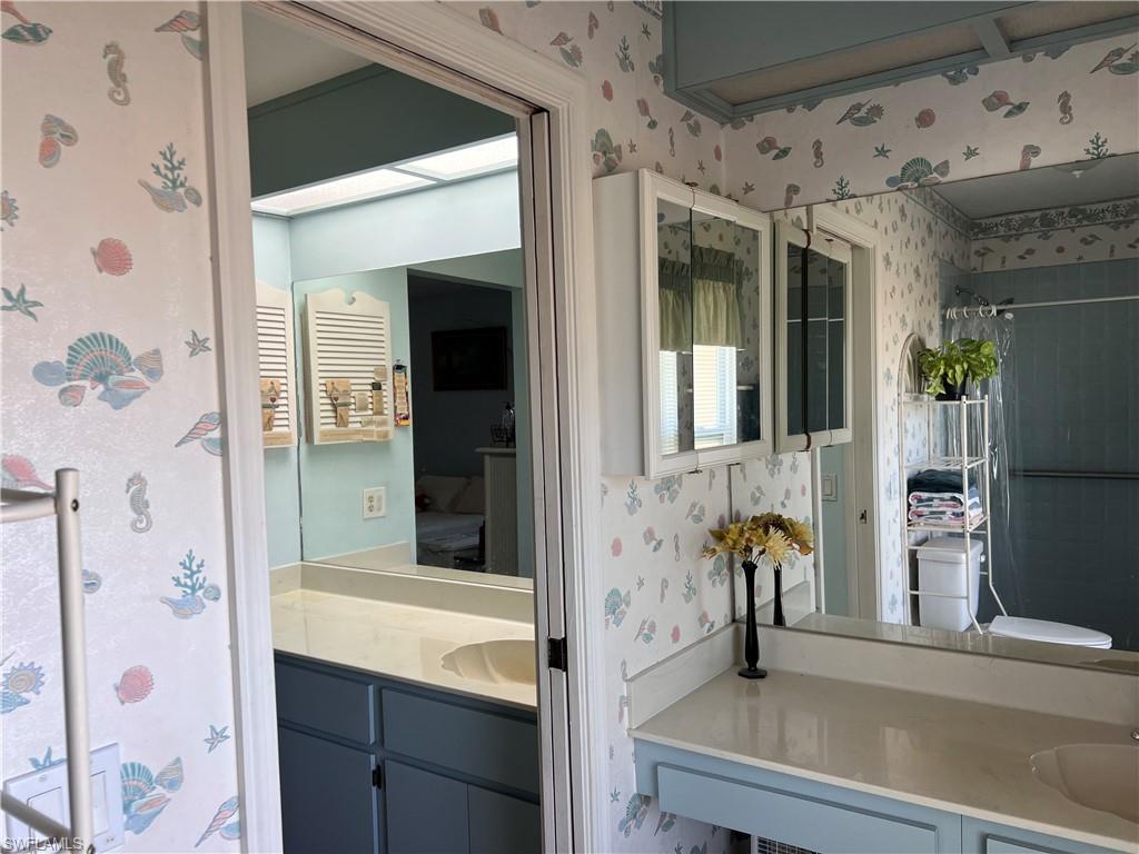140 Bordeaux Circle Naples, FL 34112 - Photo 14 of 22 a bathroom with a sink and a mirror