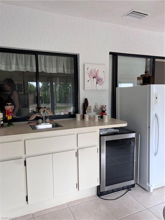 140 Bordeaux Circle Naples, FL 34112 - Photo 19 of 22 a kitchen with stainless steel appliances a sink and a refrigerator