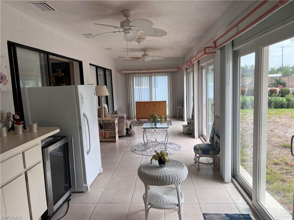 140 Bordeaux Circle Naples, FL 34112 - Photo 20 of 22 a living room with furniture a flat screen tv and a large window