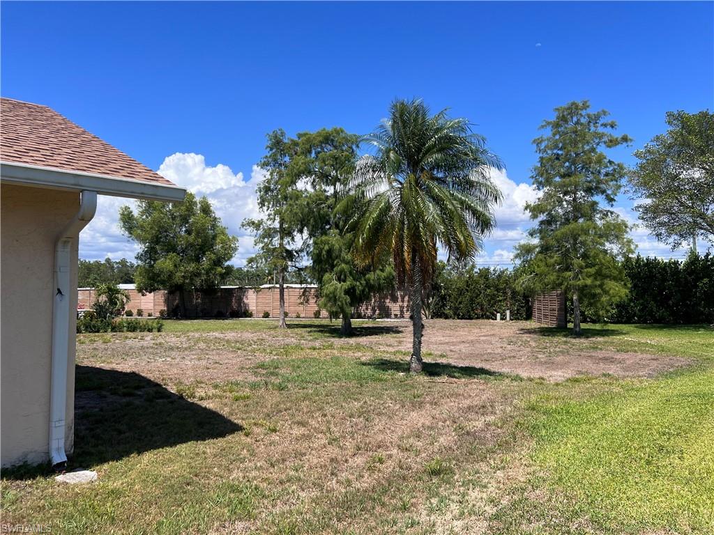 140 Bordeaux Circle Naples, FL 34112 - Photo 3 of 22 a view of a dry yard with trees