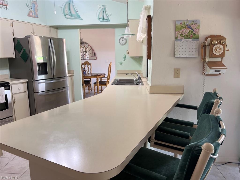 140 Bordeaux Circle Naples, FL 34112 - Photo 7 of 22 a view of kitchen with furniture and stainless steel appliances