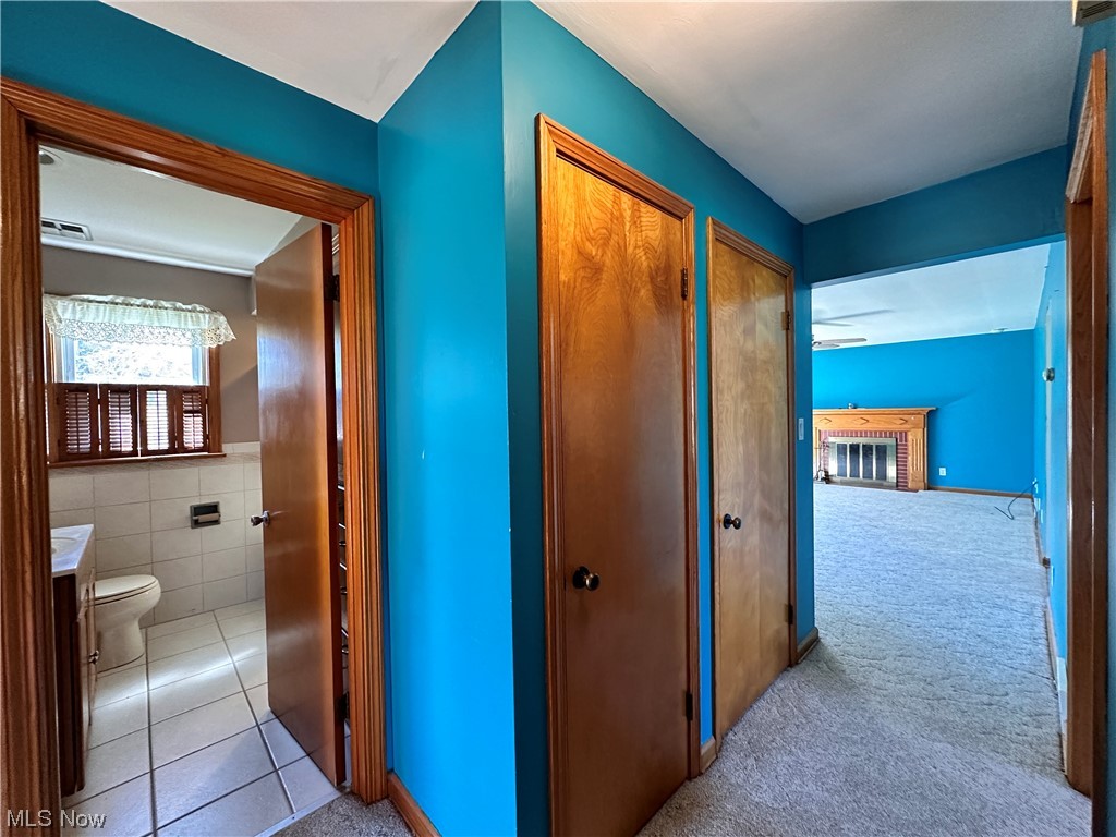 11617 Springfield Road North Lima, OH 44452 - Photo 19 of 28 Hallway featuring cedar closet and additional closet