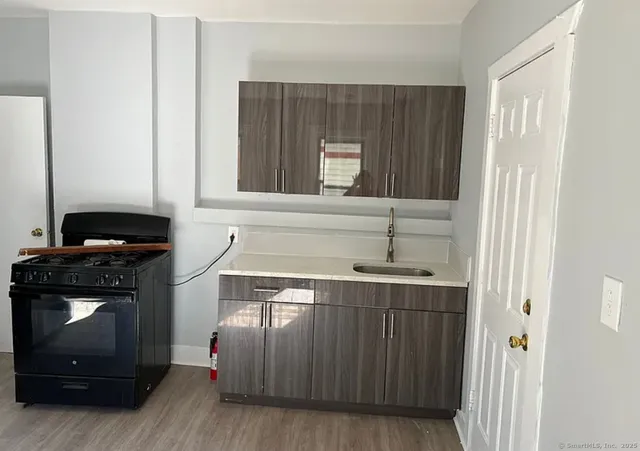 a kitchen with a cabinets and a stove top oven
