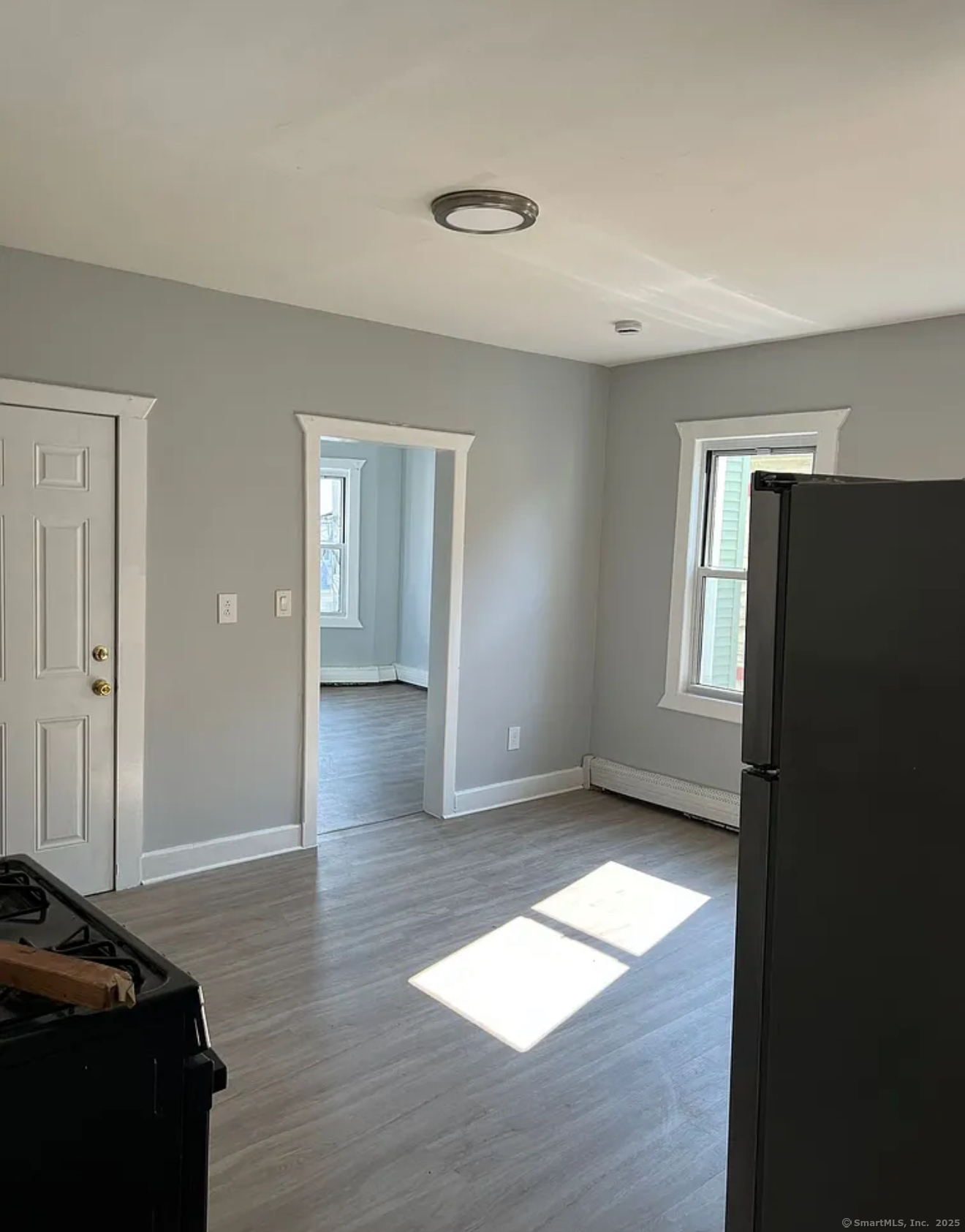651 Maple Street, Unit 2 Bridgeport, CT 06608 - Photo 2 of 4 a view of livingroom with hardwood floor and hallway