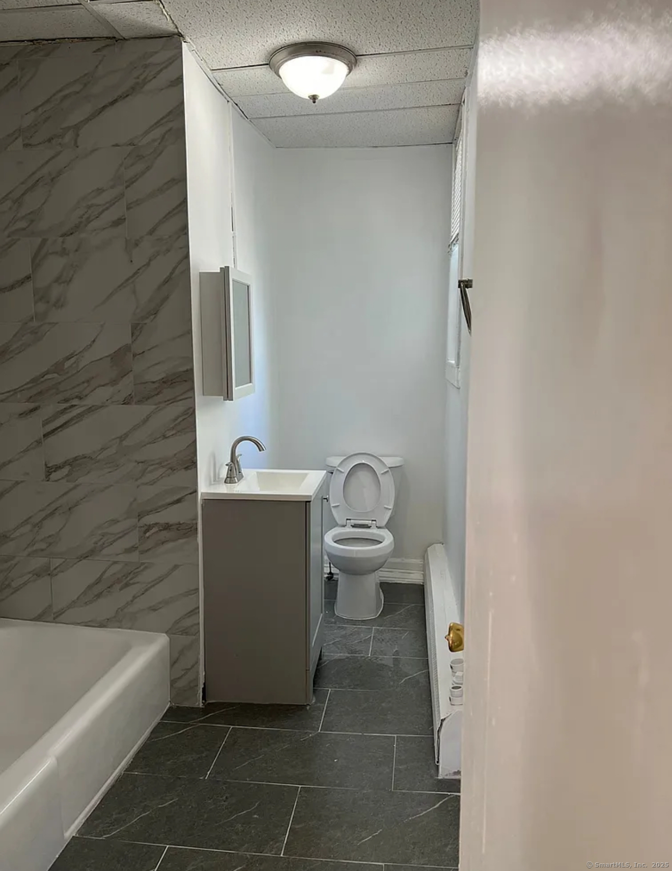 651 Maple Street, Unit 2 Bridgeport, CT 06608 - Photo 4 of 4 a bathroom with a sink a toilet and bathtub