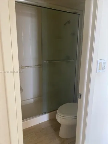 a bathroom with a toilet and a shower