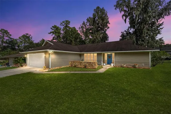 a front view of a house with patio and garden